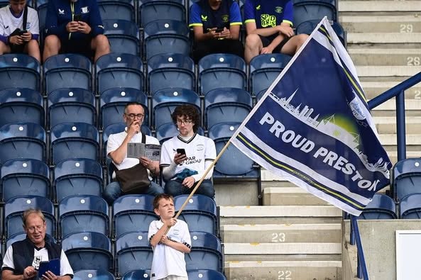 Proud Preston flag held in a Deepdale stand.