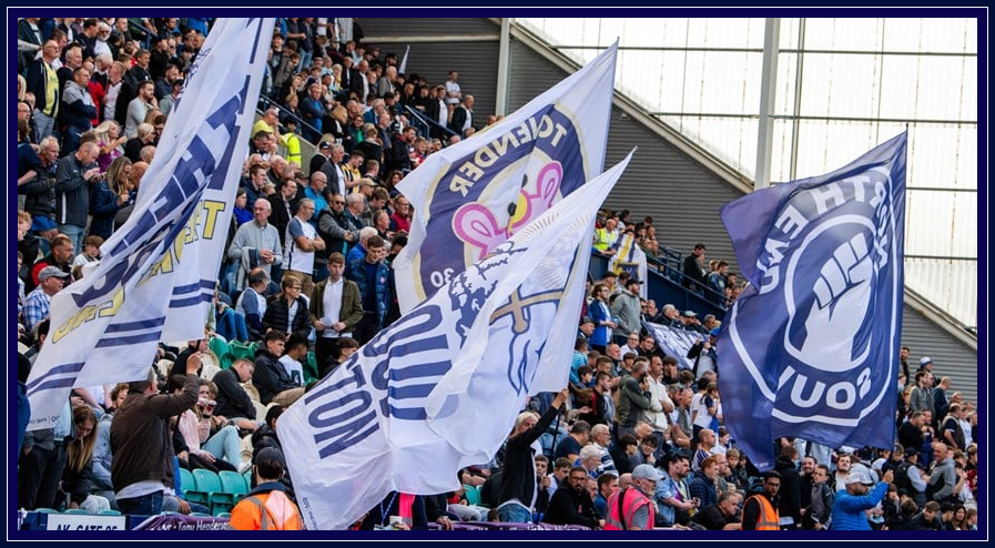Large supporter flags in the Deepdale stand.