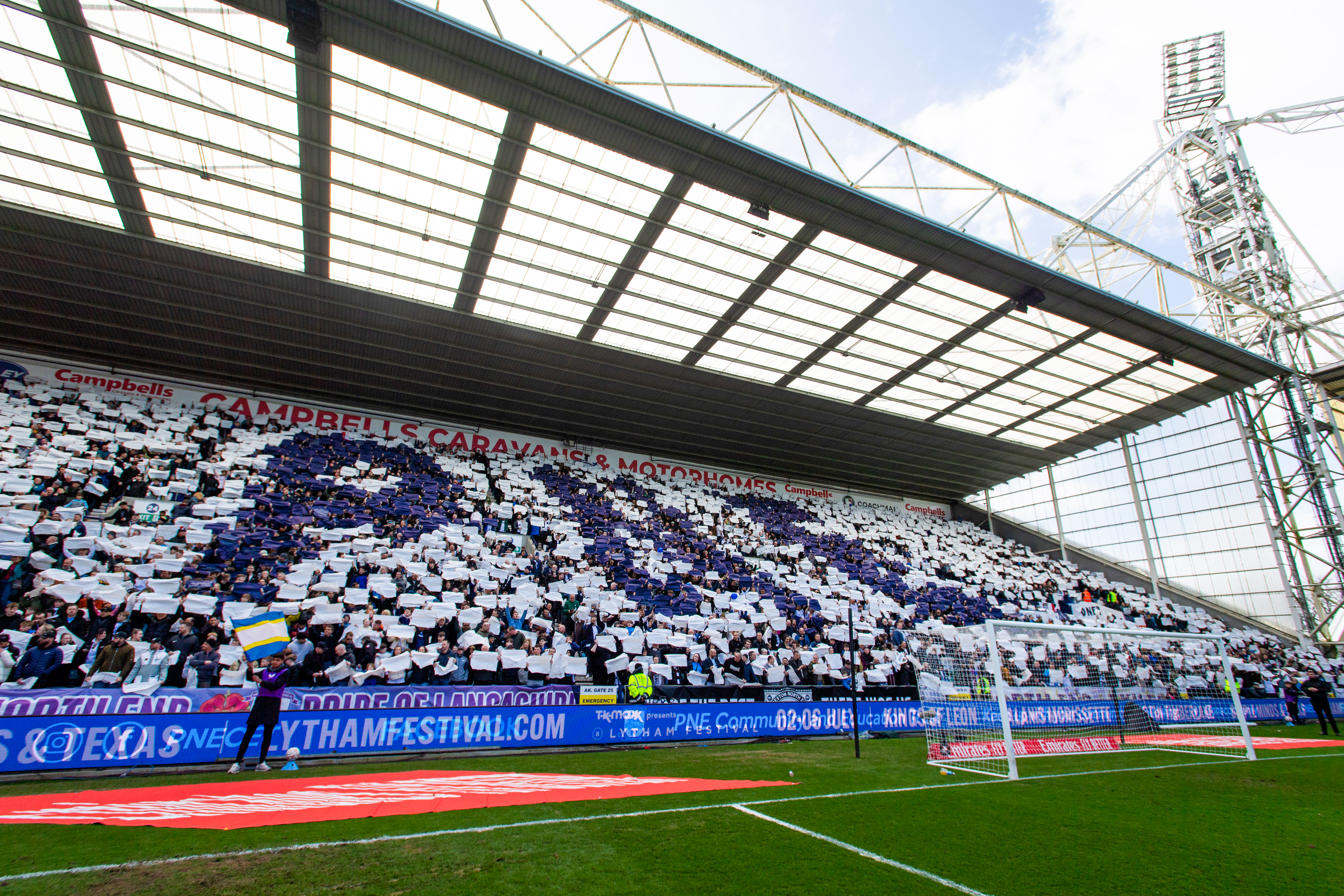 Fans waving flags at Deepdale during a match (slide 1)